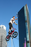 New South Wales, Australia, Sydney, circular quay, performer, performers, acrobat, acrobats, acrobatic, acrobatics, man, men, male, males, balance, balances, balancing, bike, bikes, bicycle, bicycles, transport, transportation, vehicle, vehicles, rope, ropes, juggle, juggles, juggling.