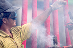 Asia, Asian, Southeast Asia, South East Asian, SE Asia, Malaysia, temple, temples, malaysian temple, malaysian temples, incense, incense stick, incense sticks, religion, religious building, religious buildings, smoke, goggles, man, men, male, males.