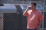 Man, Men, Male, Males, station, stations, railway station, railway stations, rail, railway, railways, platform, platforms, railway platform, railway platforms, communication, communicate, communicates, communicating, fence, fences, train, trains, phone, phones, telephone, telephones, mobile phone, mobile phones, mobile, mobiles, communication, communicate, communicating, cell phone, cell phones, cell telephone, cell telephones, cellular, cellular phone, cellular telephone, mobile phone, mobile phones, outdoors, station, stations, railway station, railway stations.