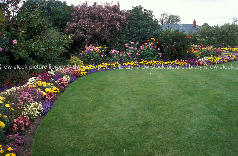A ROYALTY FREE IMAGE OF GARDEN FEATURING LUSH LAWN AND BORDER GARDEN