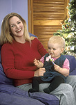 Mother, Mothers, Parent, Parents, parenting, parenthood, baby, babies, people, child, children, christmas, Christmas scene, Christmas scenes, mother and child, mother and children, mother and baby, mothers and babies, mother with child, mother with children, mothers with children, present, presents, christmas present, christmas presents, smile, smiles, smiling, happy, happiness, AM04,