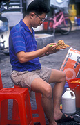 Asia, Asian, Southeast Asia, South East Asian, SE Asia, Malaysia, people, man, men, male, males, eat, eats, eating, noodles, chopstick, chopsticks.