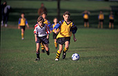 People, child, children, puberty, Sport pictures, Sports, football, footballs, football game, football games, run, runs, running, ball, balls, adolescent, adolescents, teenager, teenagers, teenage boy, teenage boys, boy, boys, male, males, soccer, soccer game, soccer games, outdoors, uniform, uniforms.