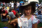 Child, children, girl, girls, hat, hats, sign, signs, war, wars, protest, protests, demonstration, demonstrations, crowd, crowds, paper.
