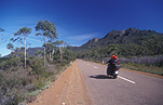 A MOTORBIKE TRAVELLING ON A SEALED ROAD, AUSTRALIA