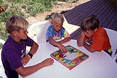 People, child, children, puberty, child, children, boy, boys, male, males, sibling, siblings, entertainment, game, games, outdoors, table, tables, chair, chairs, teenager, teenagers, teenage boy, teenage boys, board game, board games, checkers game, checkers games, checkers, chinese checkers, board game, board games.