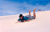 Australia, qld, queensland, moreton, moreton island, teenager, teenagers, adolescent, adolescent, boy, boys, male, males, people, child, children, puberty, teenage boy, teenage boys, dune, dunes, sand dune, sand dunes, beach, beaches, sand, toboggan, toboggans, tobogganing, hat, hats.