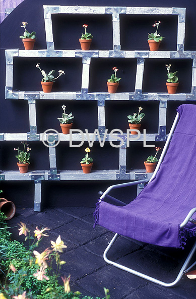 OUTDOOR FURNITURE AND GARDEN SHELVES CONTAINING POTTED PLANTS