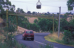 Road, roads, sealed road, sealed roads, power, power line, power lines, power supply, electricity, pulley, pulleys, goods pulley, goods pulley, australia, car, cars, vehicle, vehicles, kandos, new South Wales, nsw, australia, motor car, motor cars, bend, bends.