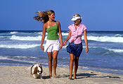 Australia, New South Wales, beach, beaches, sand, coast, coasts, coastline, coastlines, shoreline, shorelines, water, cavalier, cavaliers, cavalier king charles, cavalier king charles spaniel, cavalier king charles spaniels, seashore, seashores, wave, waves, people, child, children, puberty, teenager, teenagers, teenage girl, teenage girls, adolescent, adolescents, female, females, Animal, Animals, dog, dogs, mammal, mammals, placental mammal, placental mammals, carnivore, carnivores, pet, pets, domestic animal, domestic animals, domestic dog, domestic dogs, spaniel, spaniels, king charles spaniel, king charles spaniel, puppy, puppies, young animal, young animals, baby animal, baby animals, cute animal, cute animals, walk, walks, walking, outdoors, sunburn, hat, hats, Royalty Free Image