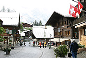 Europe, Switzerland, Swiss, Gstaad, architecture, street, streets, snow, snow scene, snow scenes, winter, house, houses, housing, chalet, chalets, flag, flags.